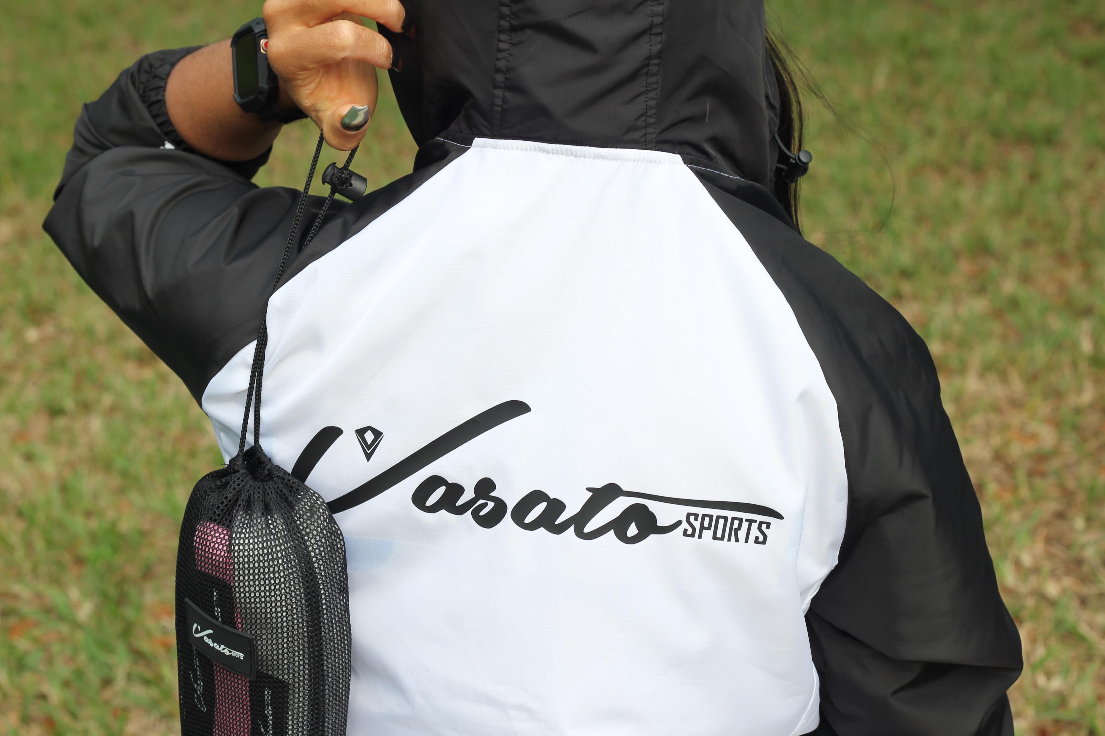 Close-up of a Vasato Sports jacket logo and mesh sports bag