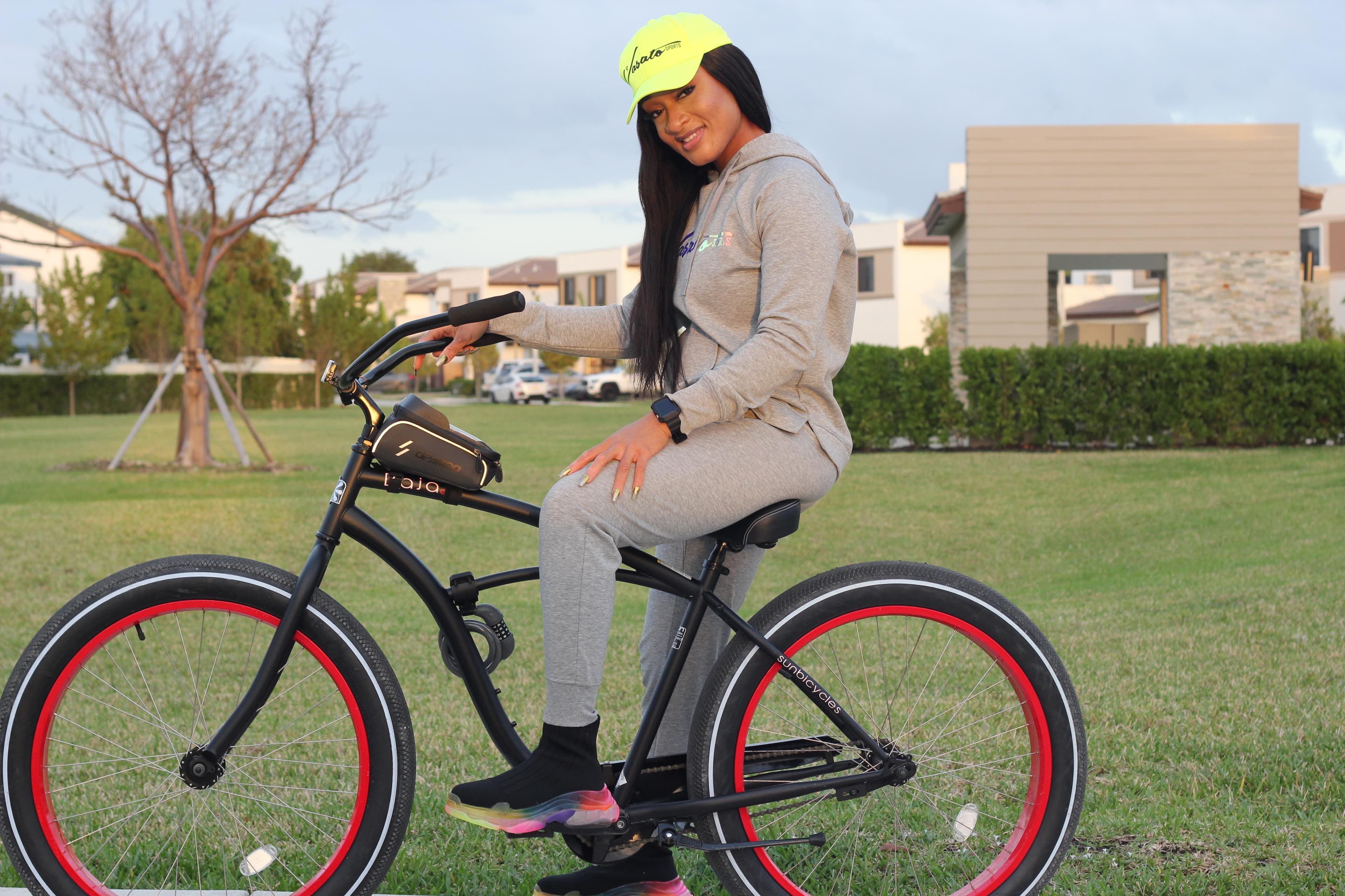 Model wearing Vasato activewear while seated on a bicycle outdoors