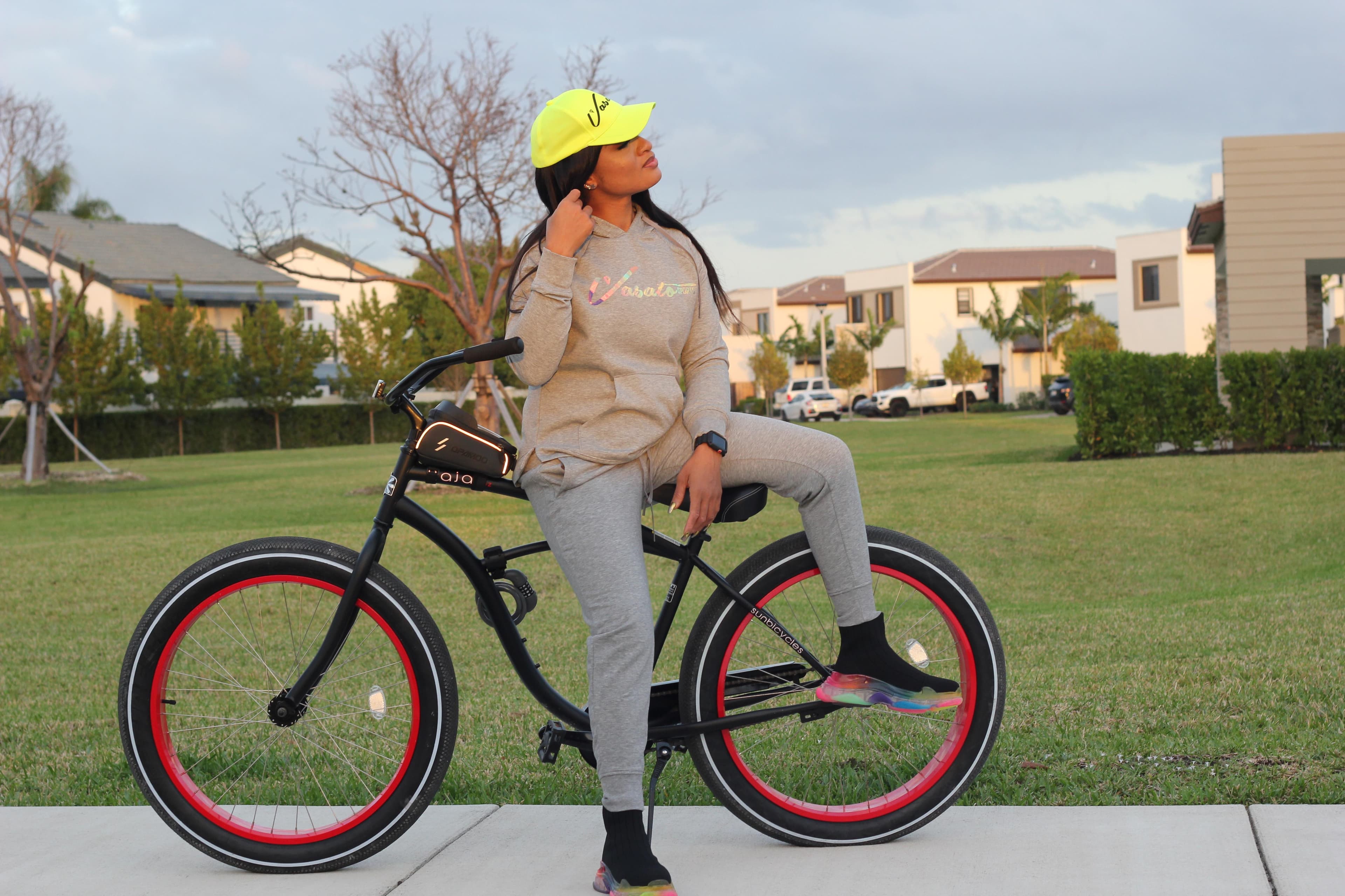 Model in Vasato activewear posing with a bicycle outdoors